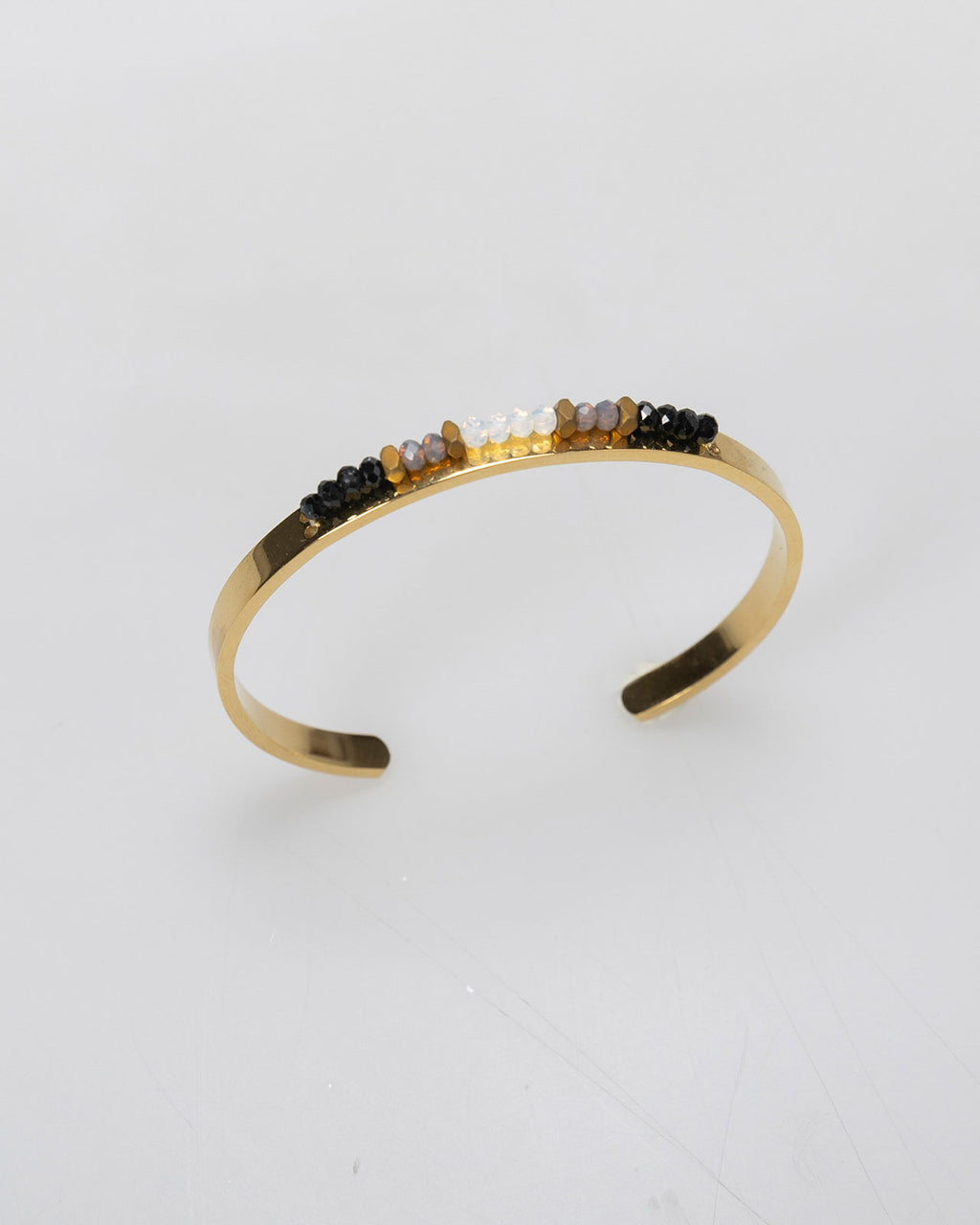 Semi-open rigid bracelet with rhinestone detail in the center