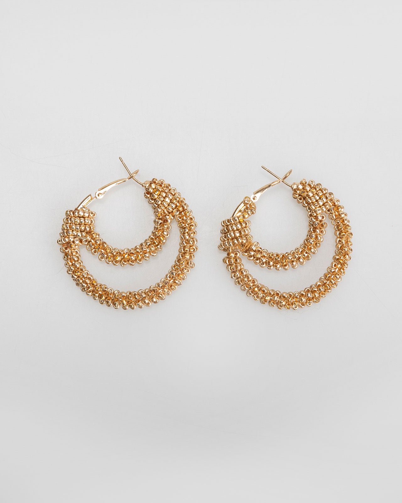 Double hoop earrings covered with mini golden rhinestones