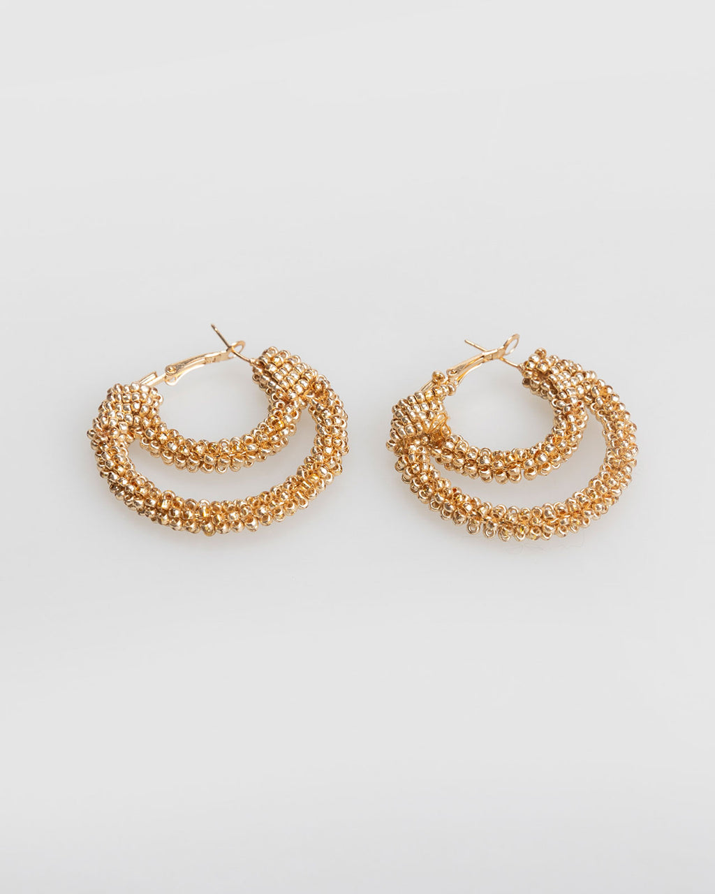 Double hoop earrings covered with mini golden rhinestones