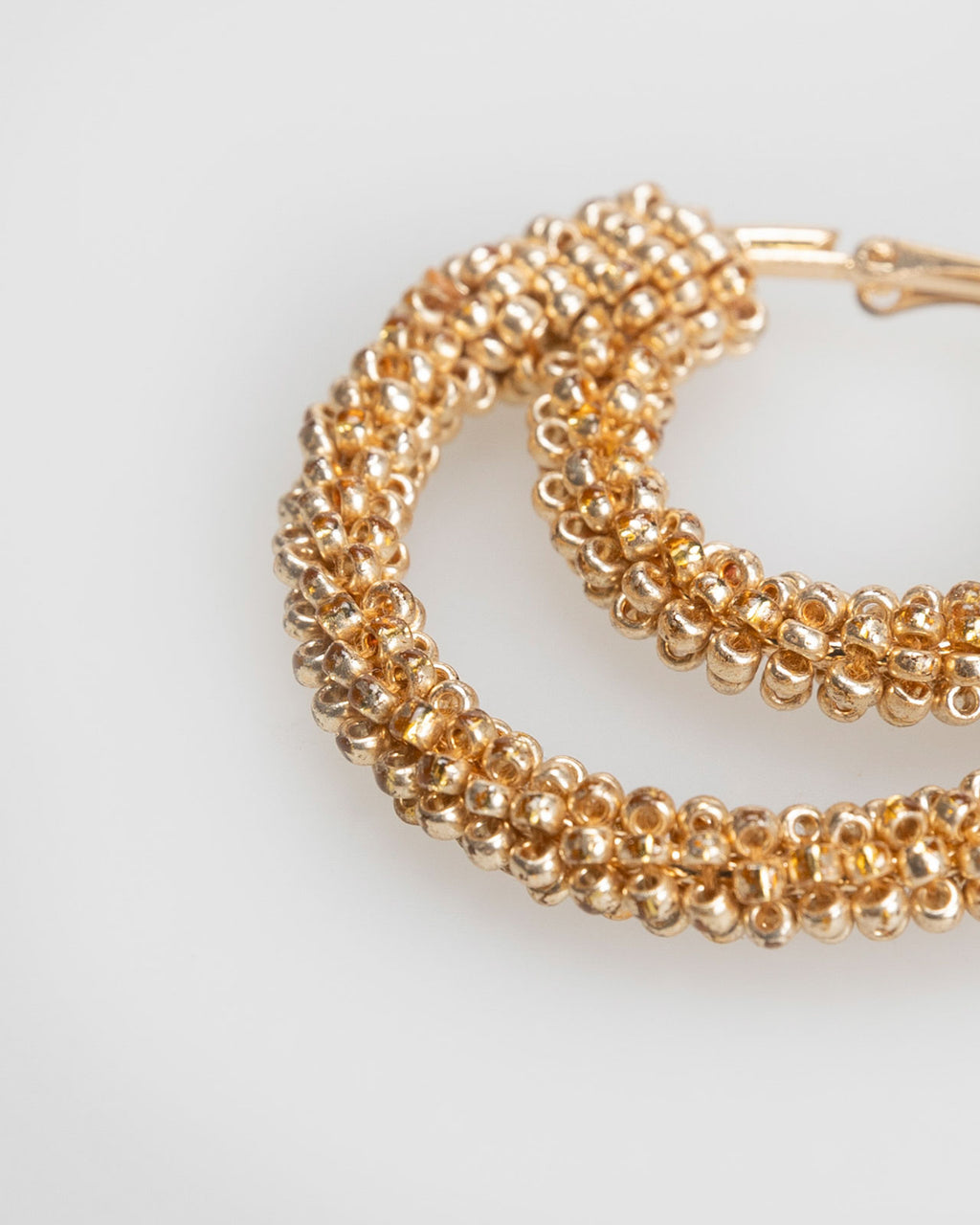 Double hoop earrings covered with mini golden rhinestones