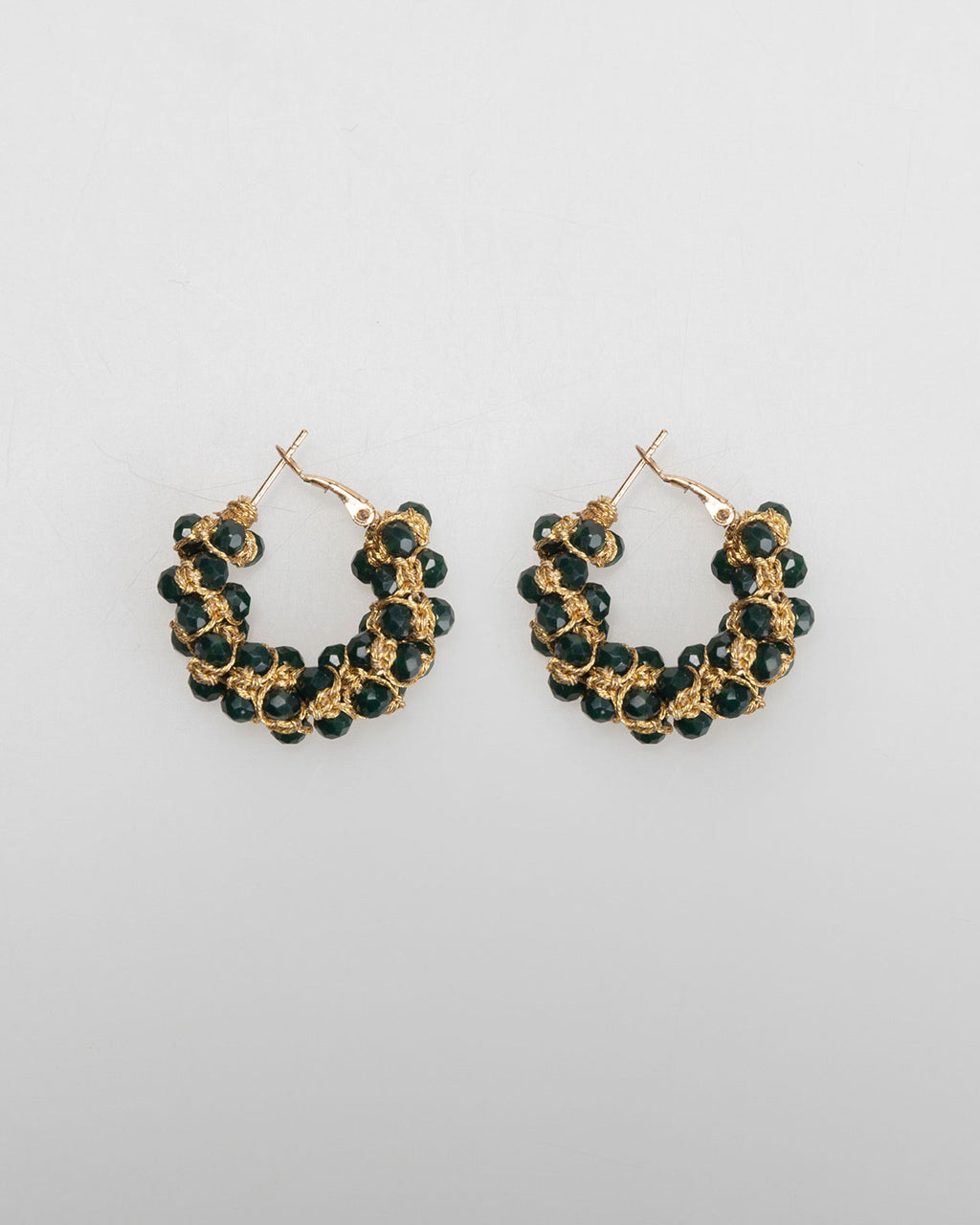 Gold-colored hoop earrings with black rhinestones