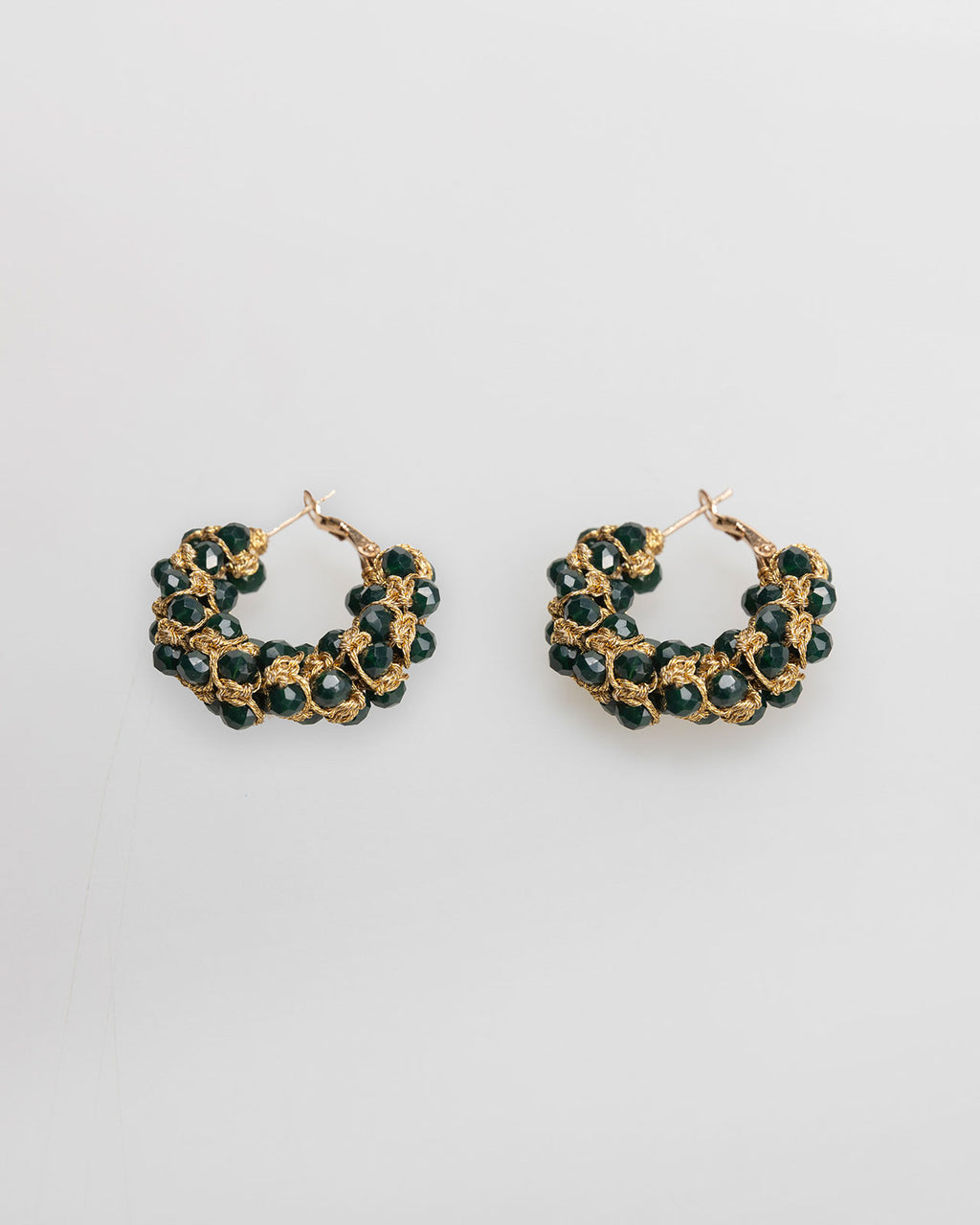 Gold-colored hoop earrings with black rhinestones