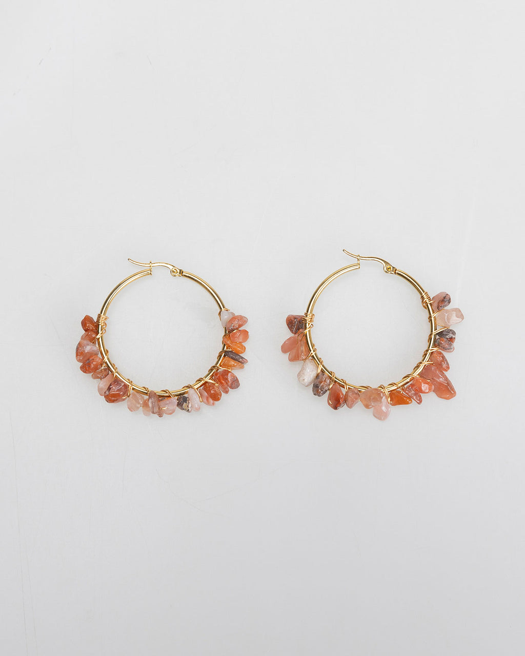 Large gold-colored hoop earrings with rhinestones