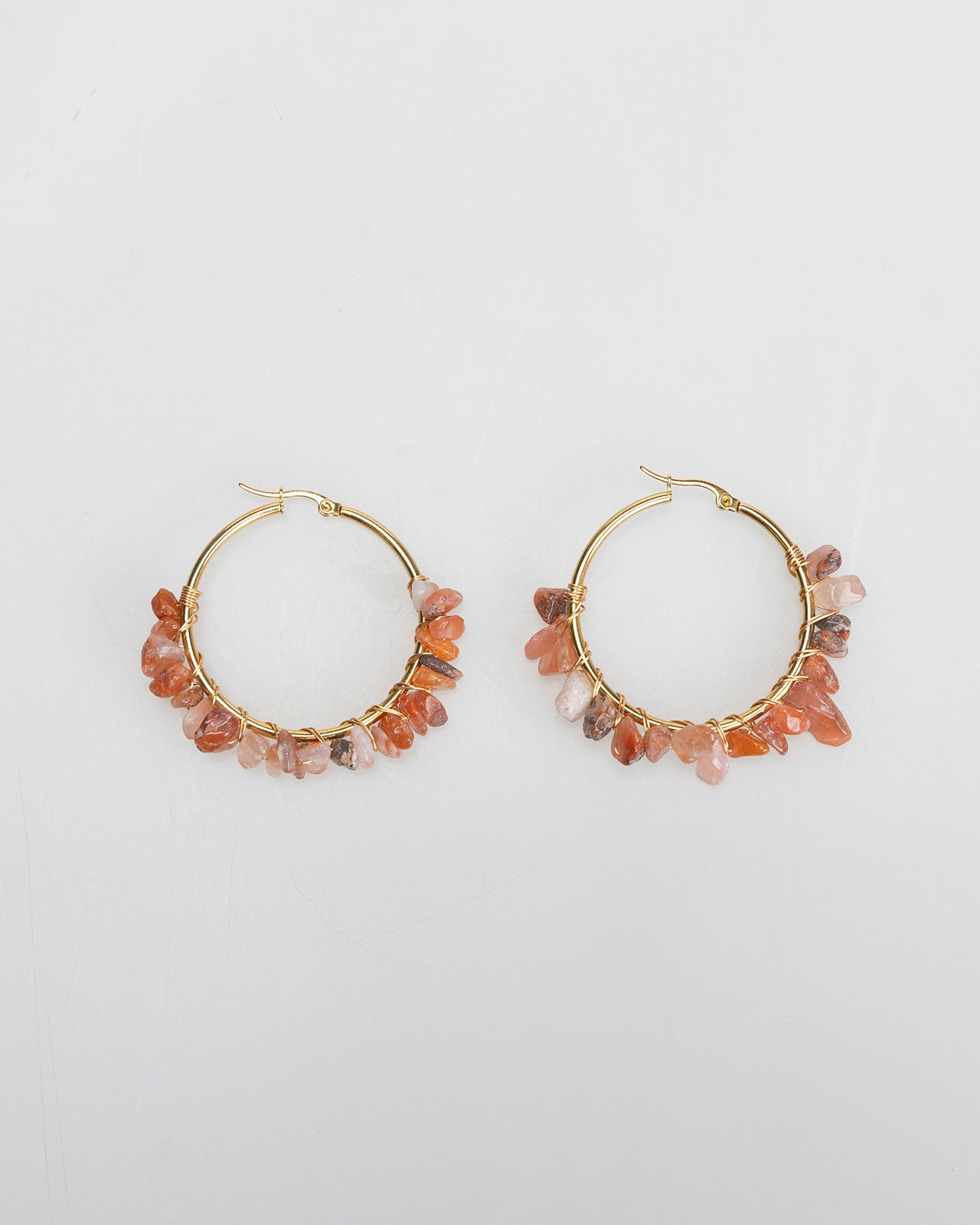 Large gold-colored hoop earrings with rhinestones