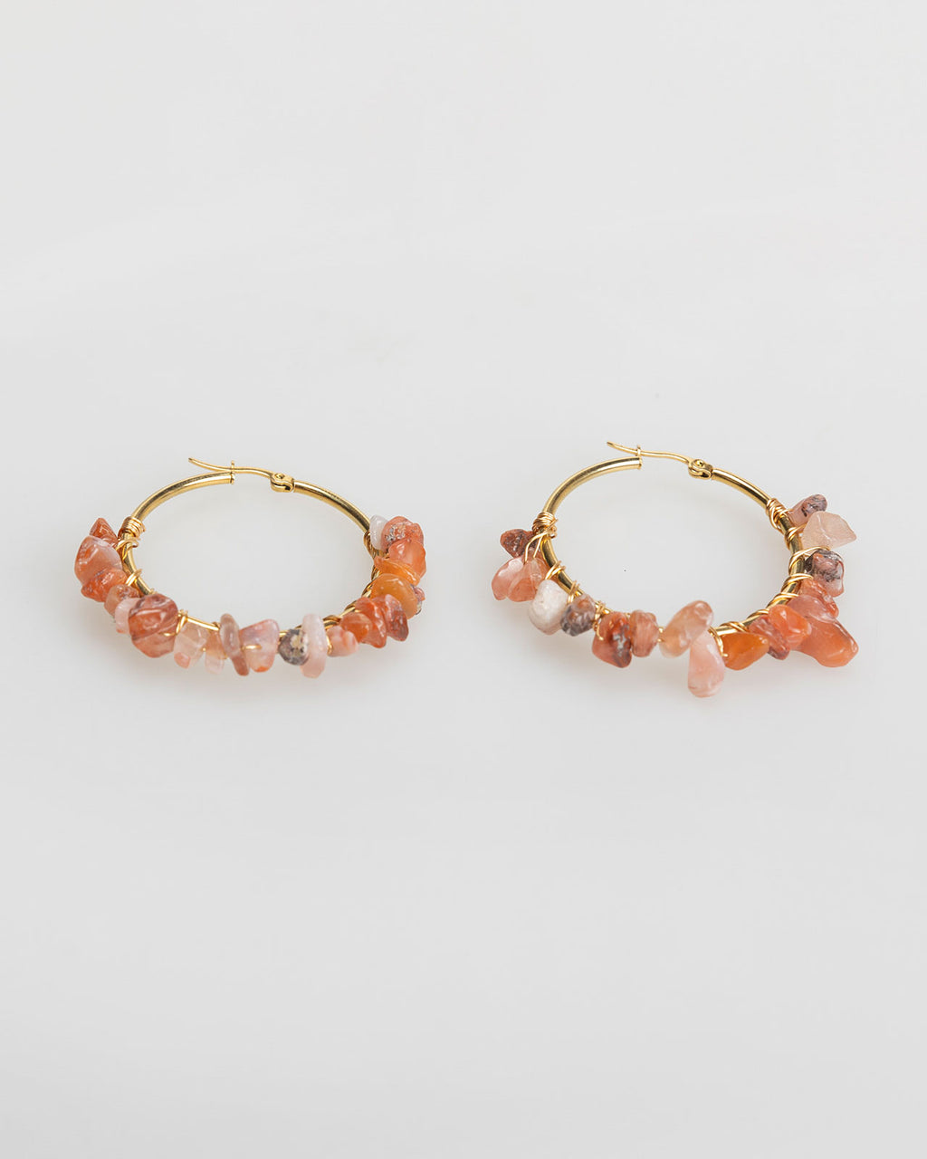 Large gold-colored hoop earrings with rhinestones