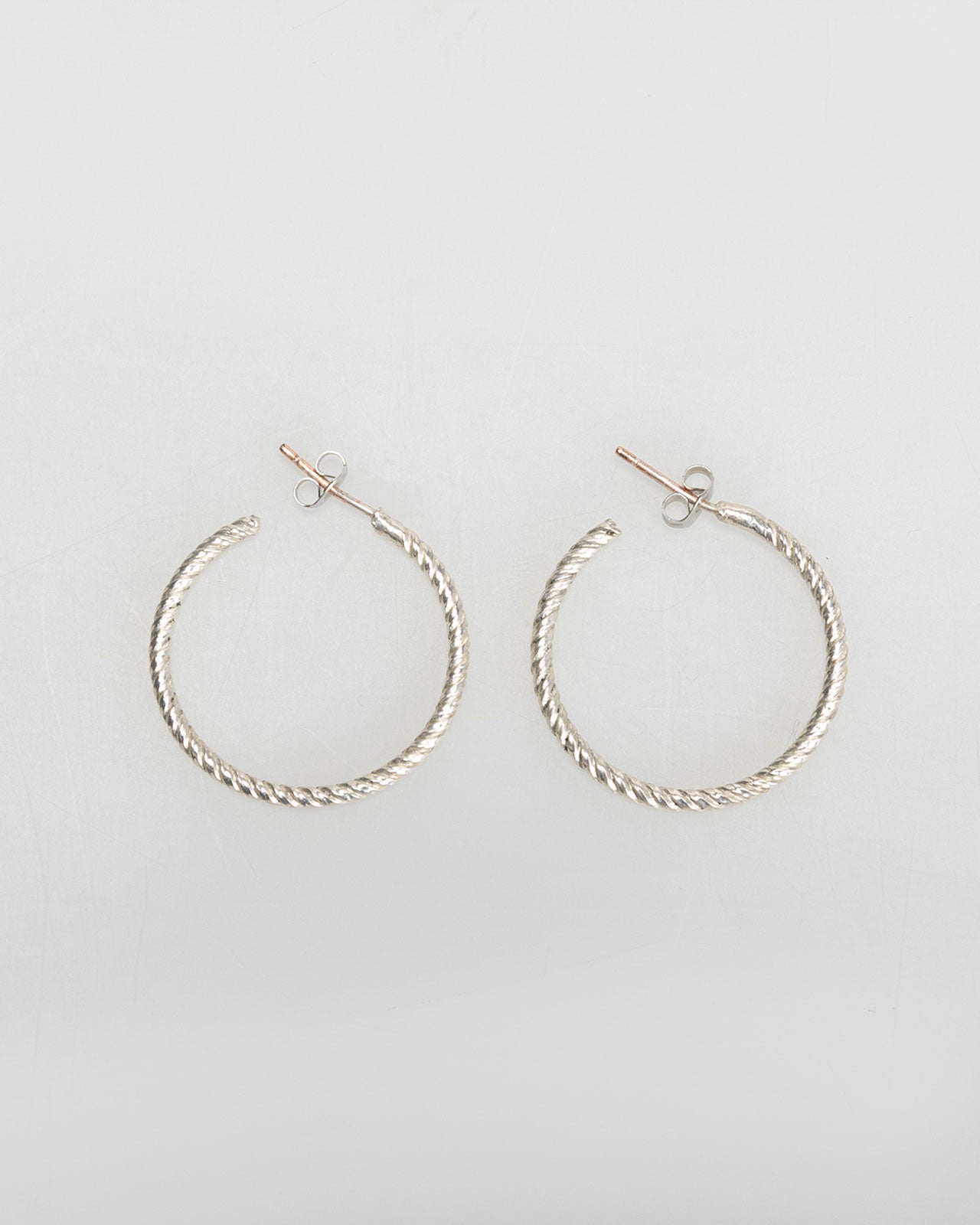 Silver-coloured embossed hoop earrings