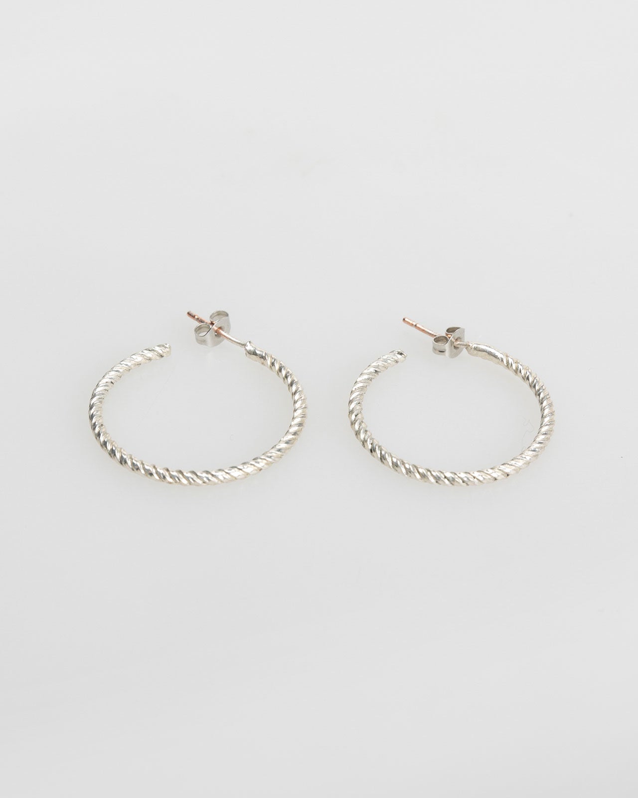 Silver-coloured embossed hoop earrings