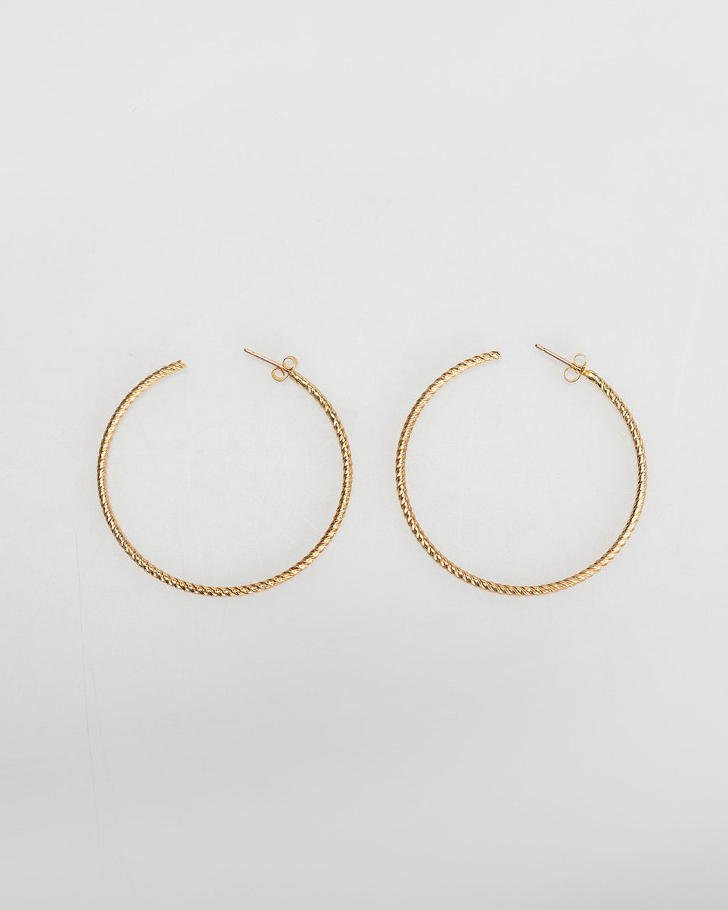 Large gold-coloured embossed hoop earrings