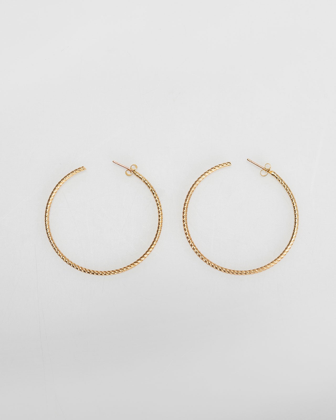 Large gold-coloured embossed hoop earrings