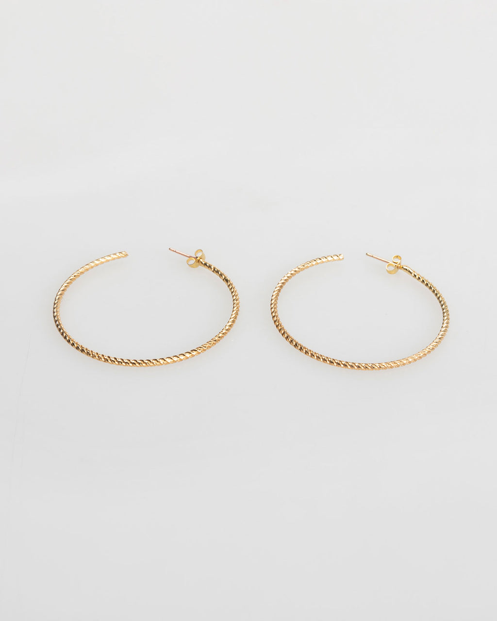 Large gold-coloured embossed hoop earrings