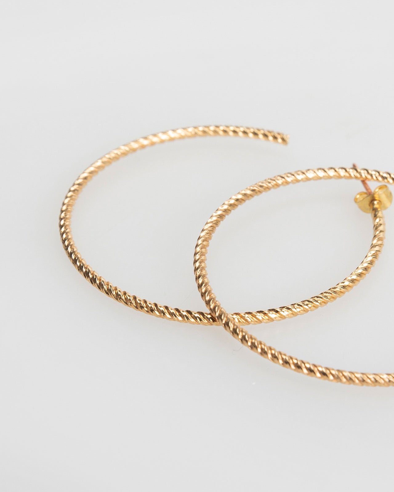 Large gold-coloured embossed hoop earrings