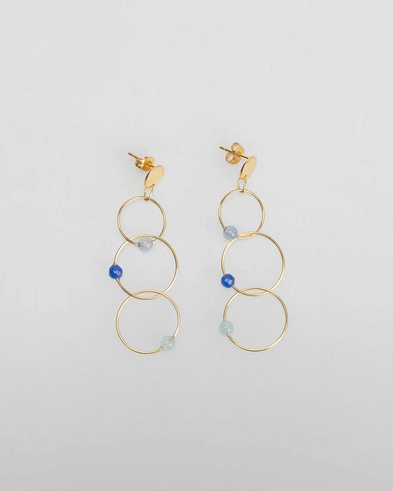 Three gold hoop earrings with rhinestone detail