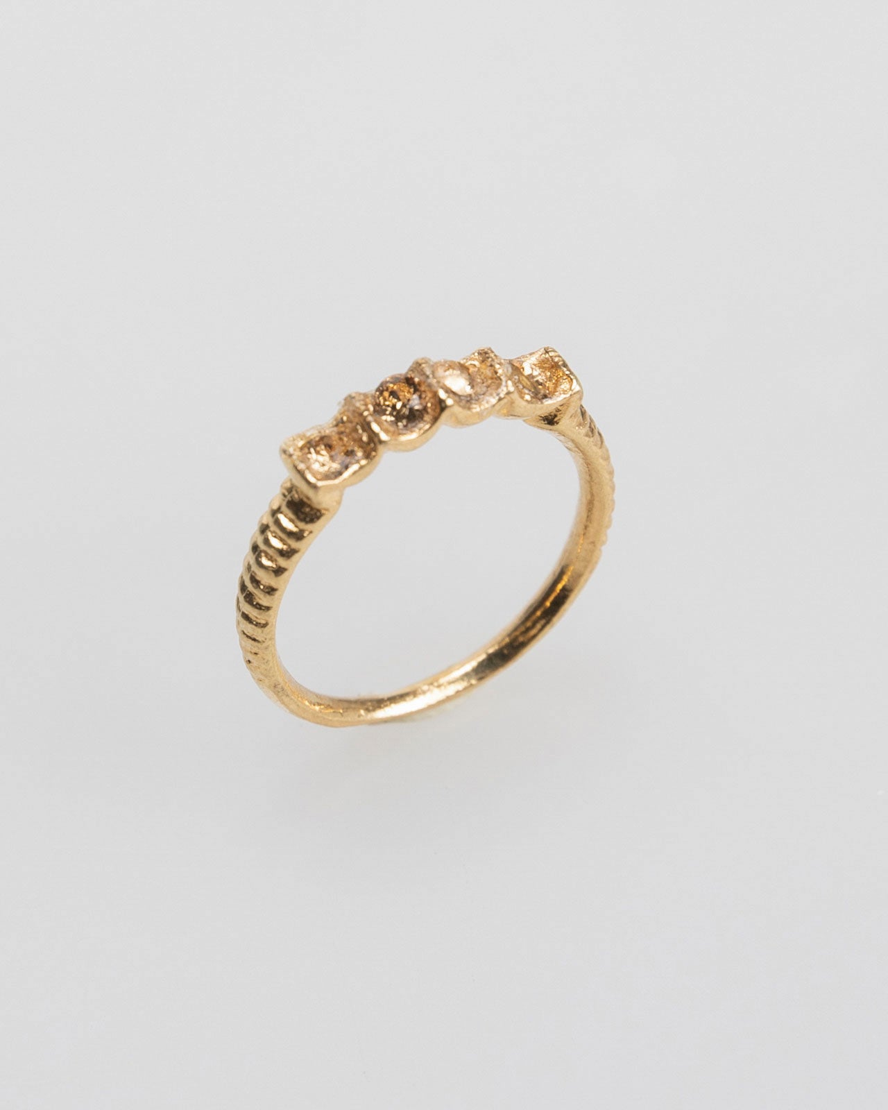 Thin gold-colored ring with colored rhinestones