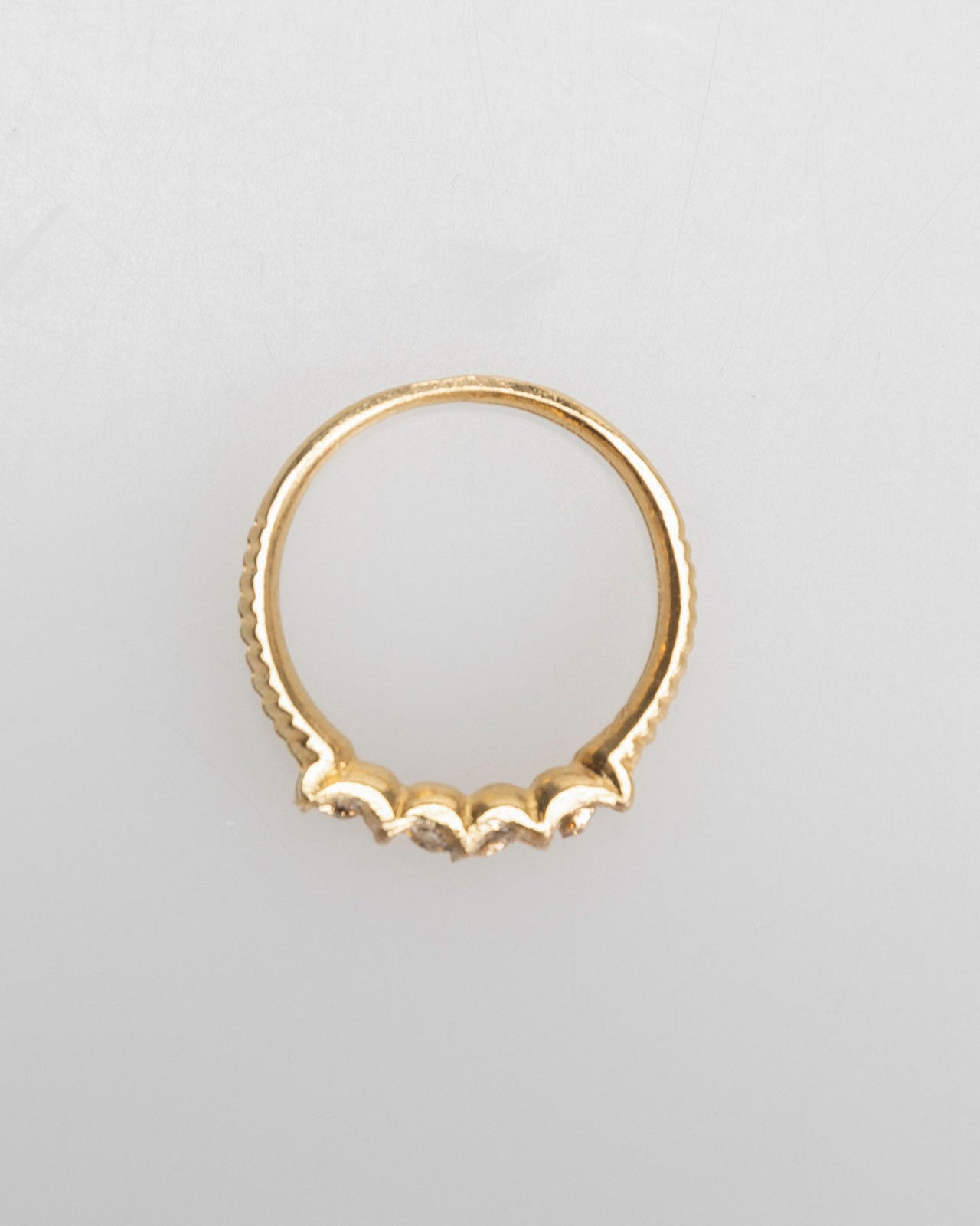 Thin gold-colored ring with colored rhinestones