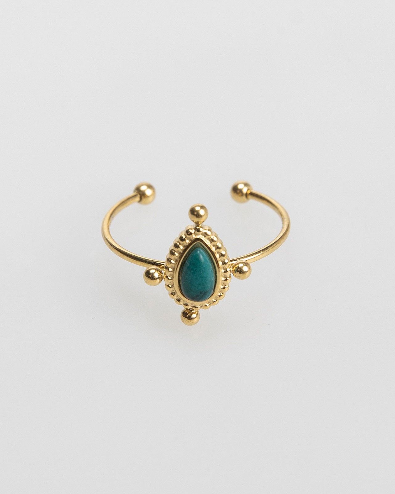 Thin gold-colored ring with colored stone