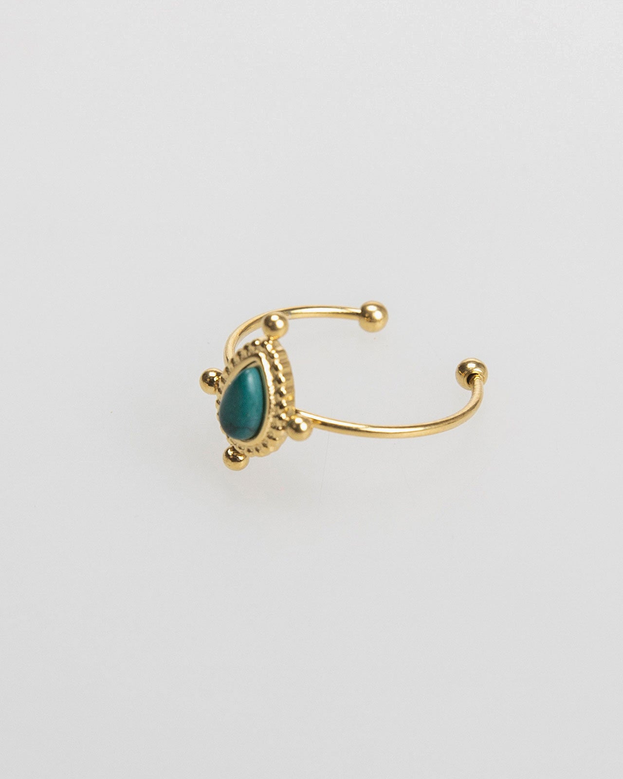 Thin gold-colored ring with colored stone