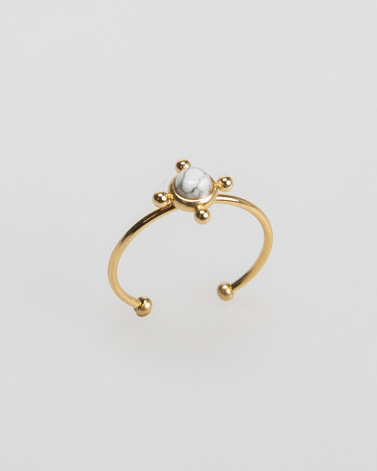 Thin gold-colored ring with colored stone