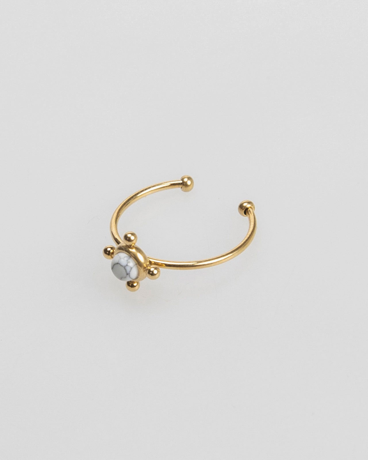 Thin gold-colored ring with colored stone