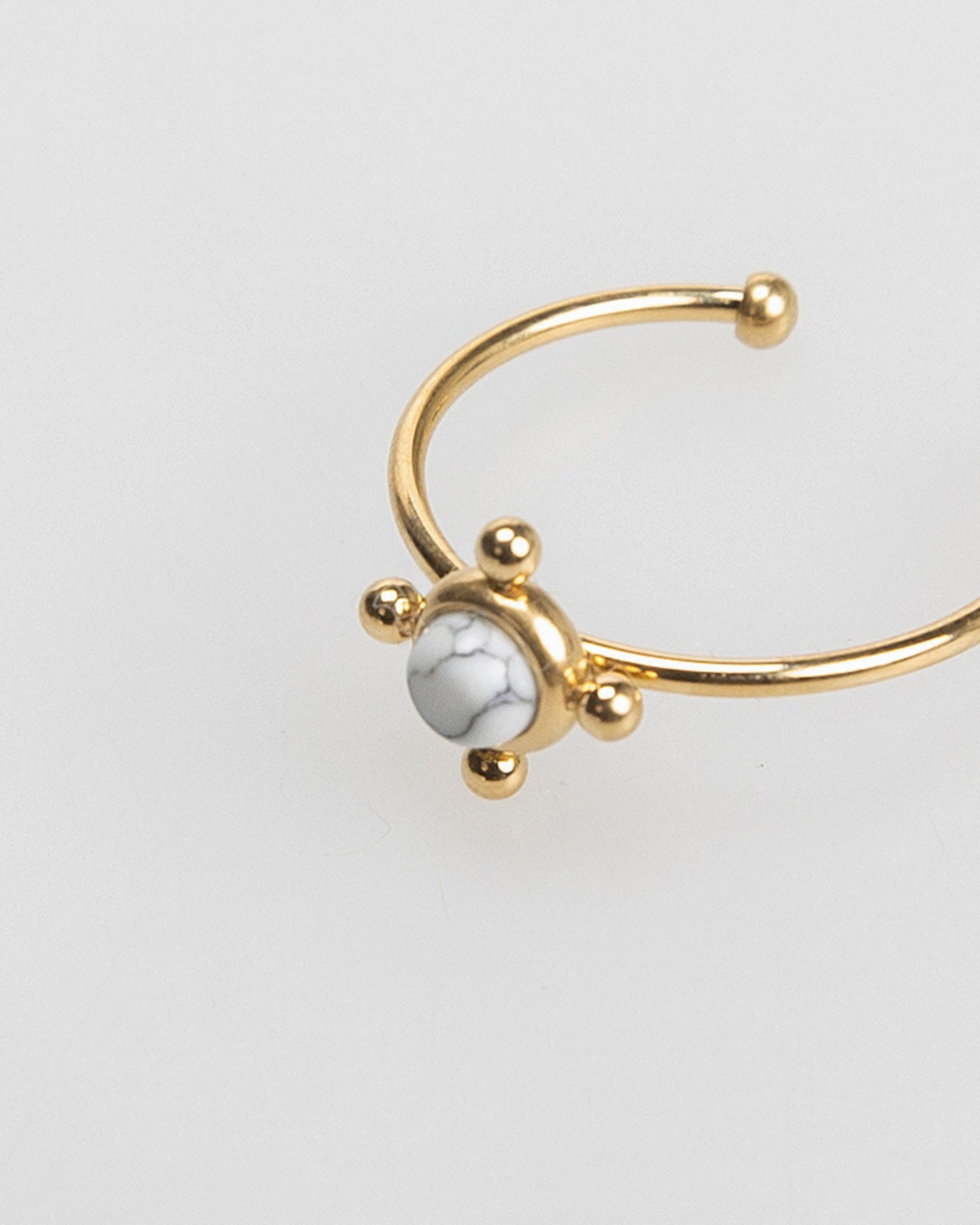 Thin gold-colored ring with colored stone