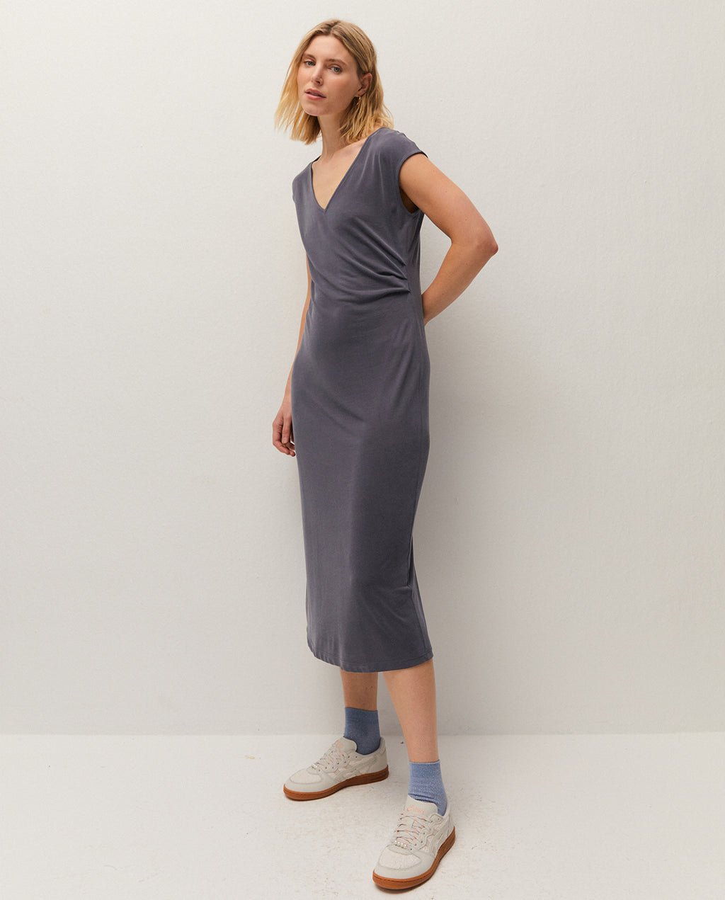 V-neck midi dress. Gathered detail at the waist