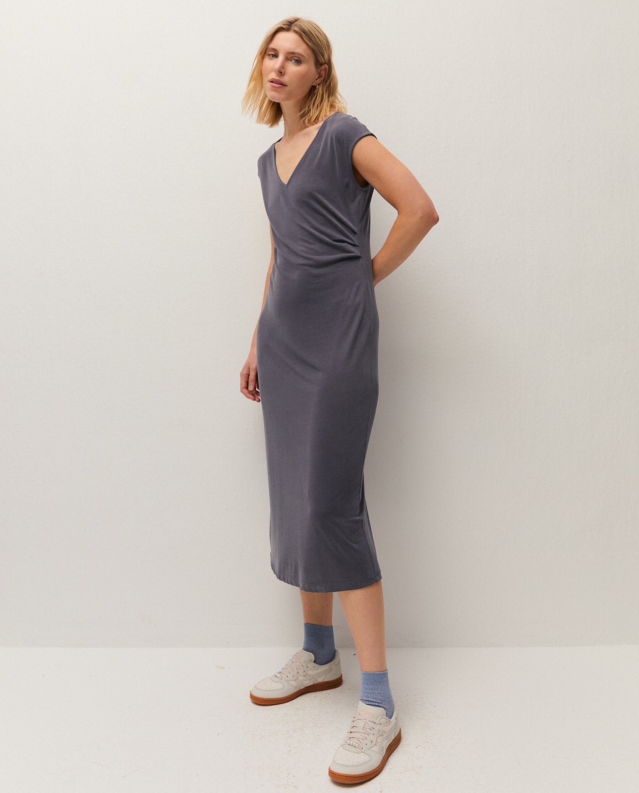 V-neck midi dress. Gathered detail at the waist