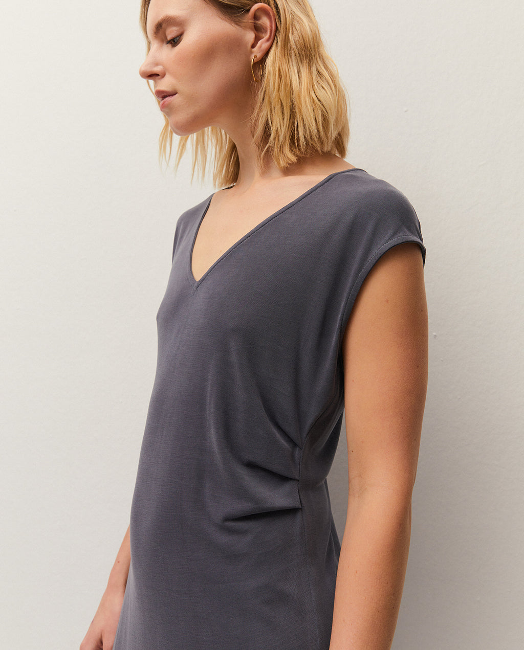 V-neck midi dress. Gathered detail at the waist